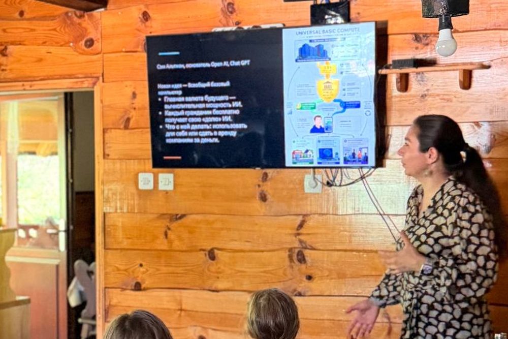 Julia Sherman presenting a slide about AI to a group of young people in a wooden camp room.